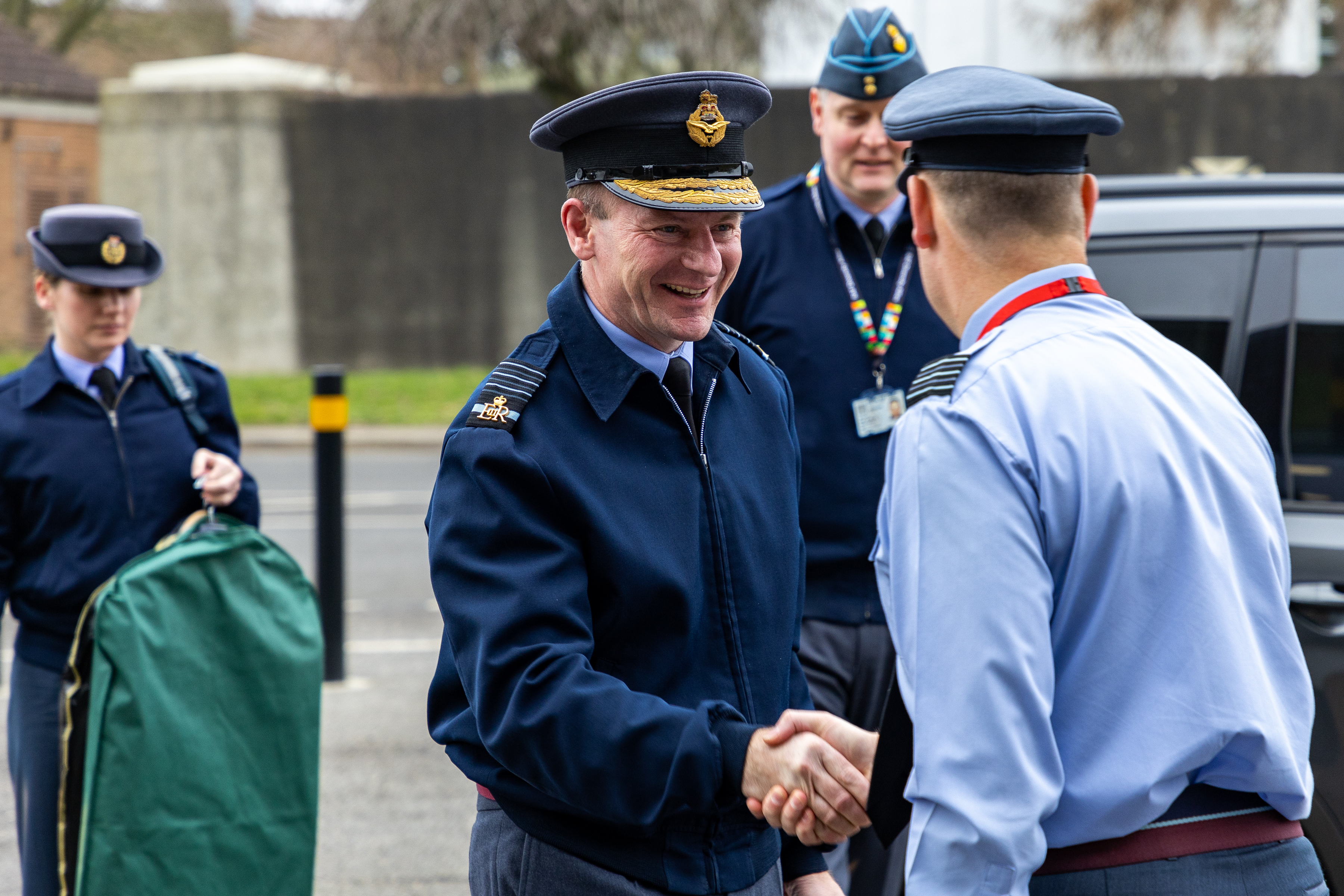 Image shows the Chief of the Air Staff and a RAF aviator shaking hands outside.